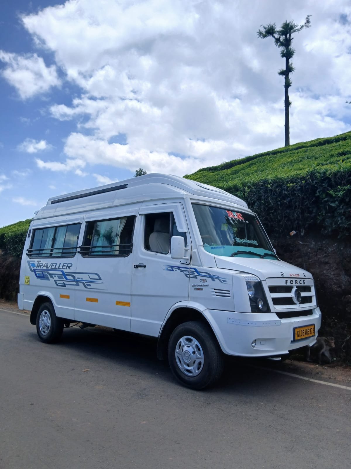 R K Travels Force Traveller in scenic hills